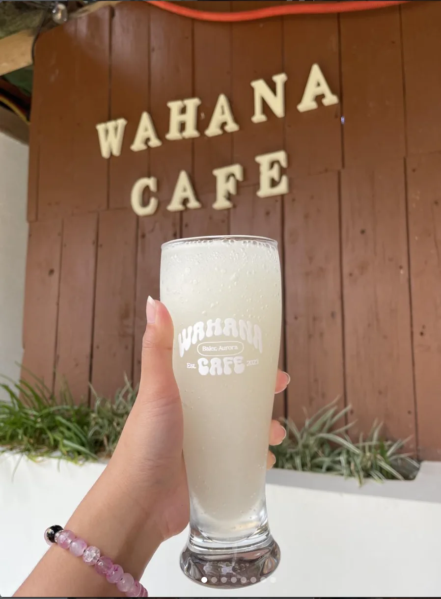 A drink held in front of the Wahana Cafe sign